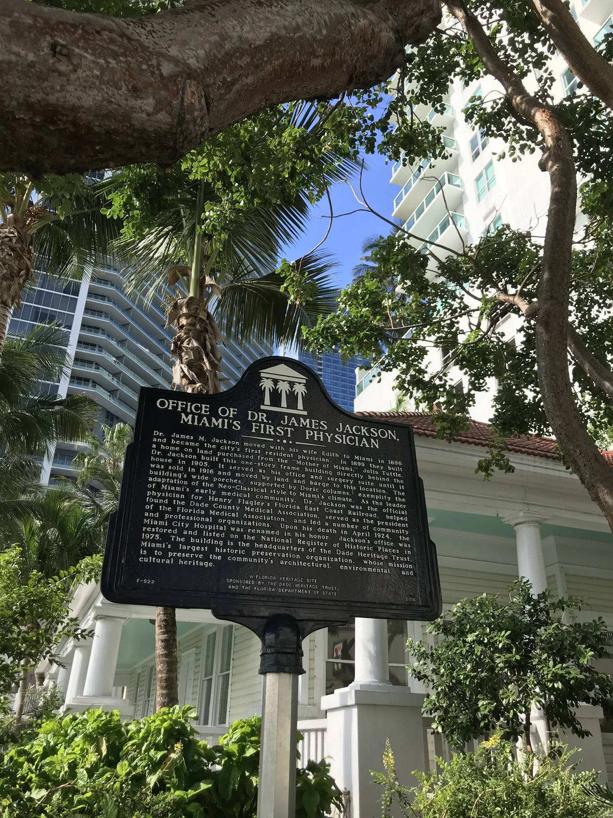 Historic marker beside a shaded building in Brickell