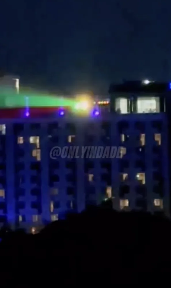 A rooftop venue with colored lights at night