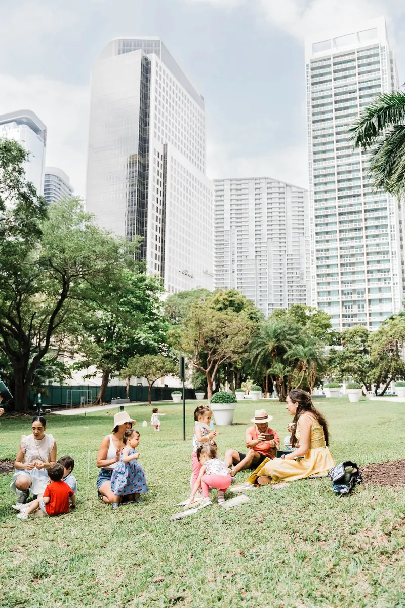 Families enjoying a gathering on the lawn in Brickell
