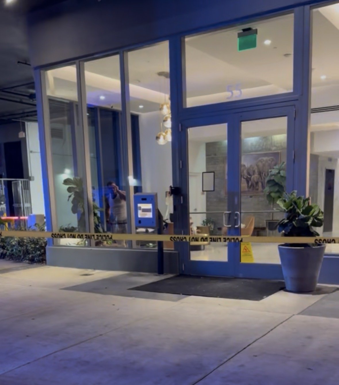 A downtown condominium entrance behind police tape