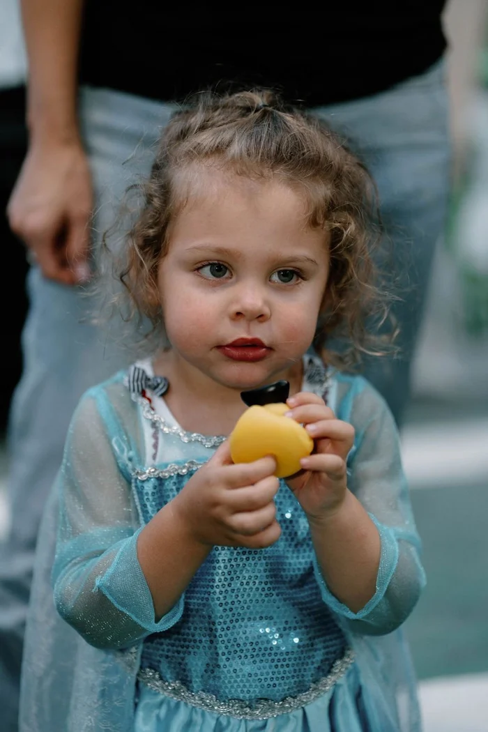 A child in a pale blue princess dress